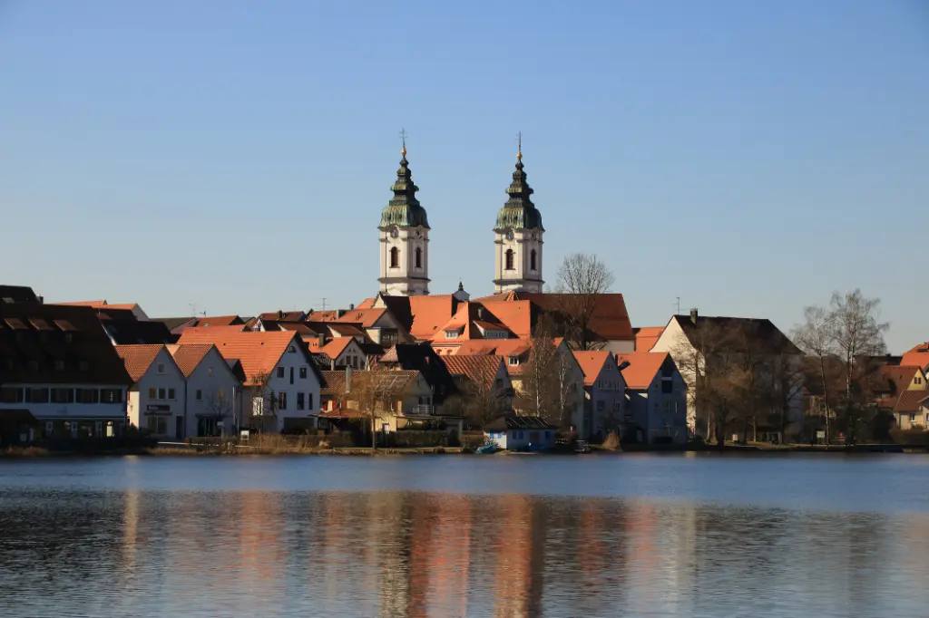 Blick auf den Ort Bad Waldsee. Die Türme der Stiftskirche spiegeln sich im Stadtsee