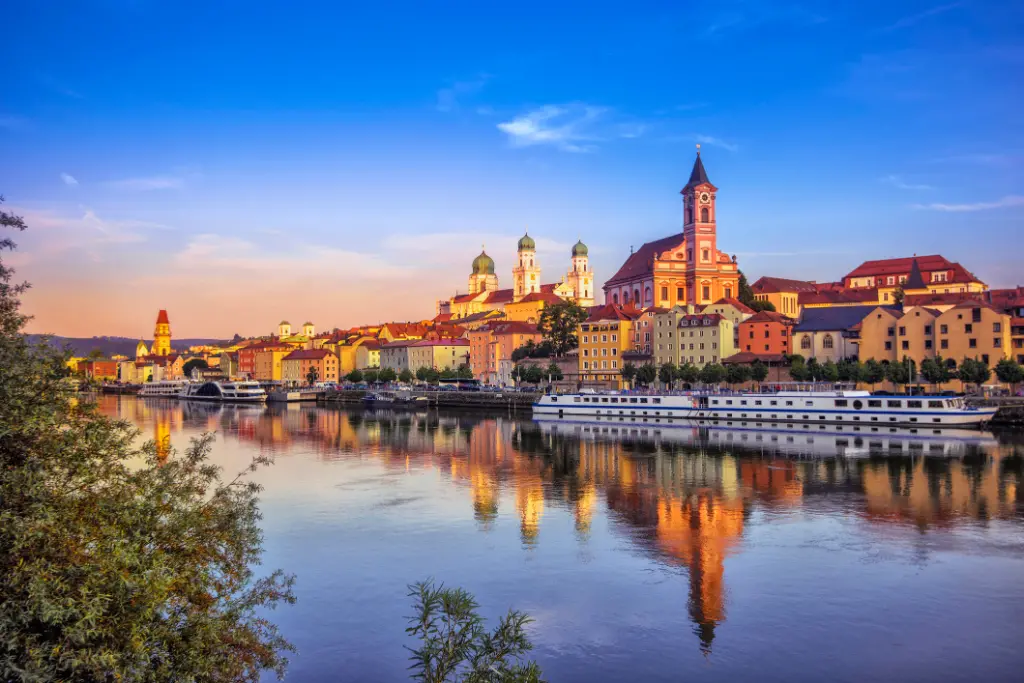 The waterfront and sightseeing boats in Passau at sunset.