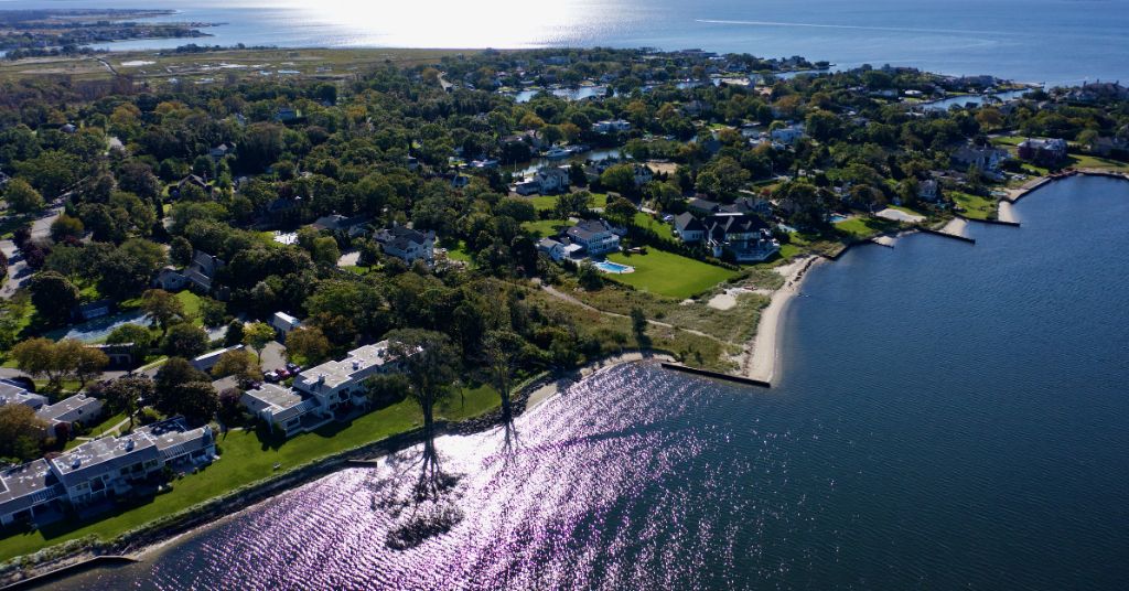 An aerial, high angle shot over Bayshore, New York showing the beautiful waters of the Great Cove on a sunny morning.
