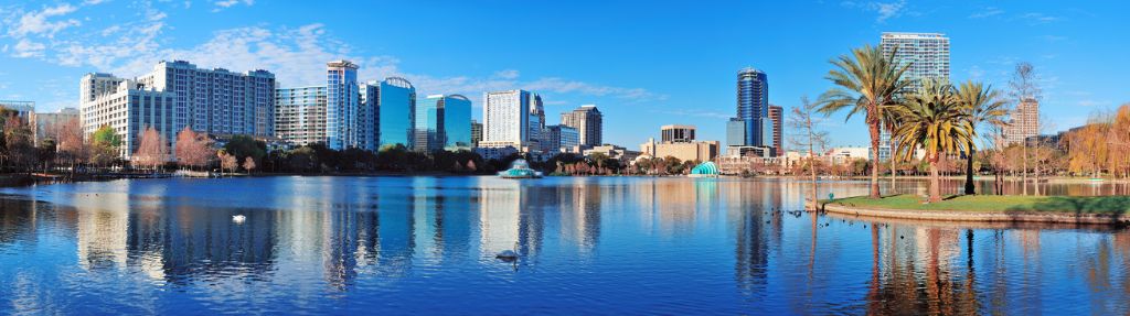 Orlando Lake Eola in the morning with urban skyscrapers and clear blue sky