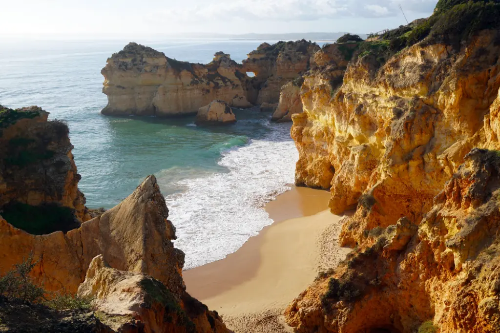 Marinha Beach very popular beach with typical rock formations as natural bridges and arches