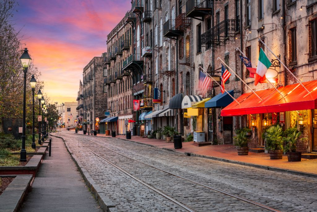 Savannah, Georgia, USA bars and restaurants on River Street at dawn.
